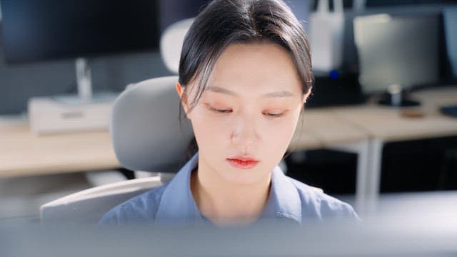 Woman talking on the phone at office desk