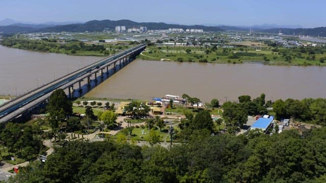 City park full of green and colorful structures on a sunny day