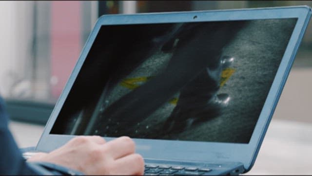 Person editing video with a laptop on set