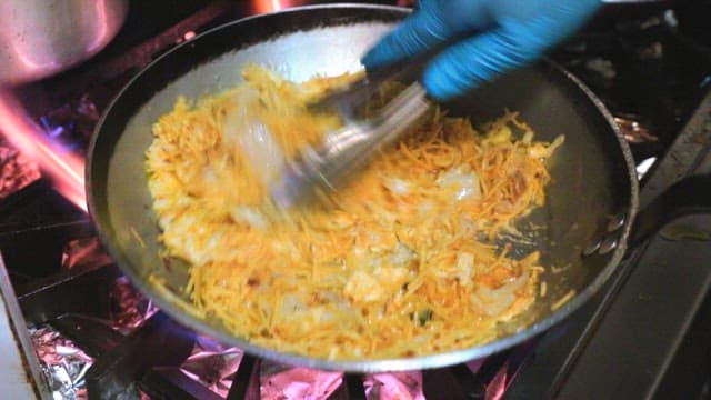 Cooking in a kitchen with flames and frying pan