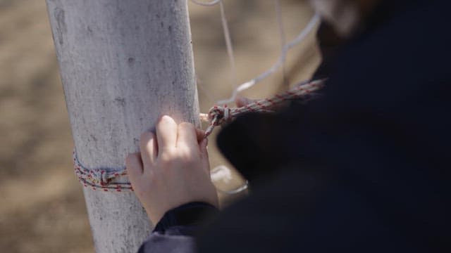 Tying Twine to a Soccer Goalpost