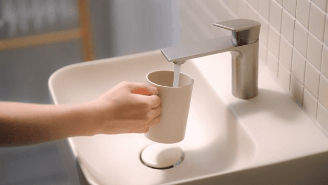 Filling a cup with water from a faucet