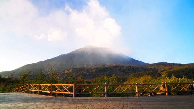 A mountain with a wooden fence in view