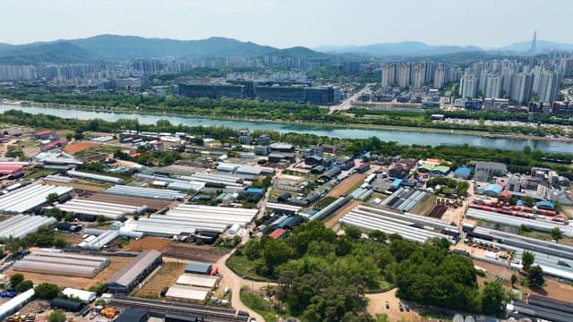 Aerial view of greenhouses near a city