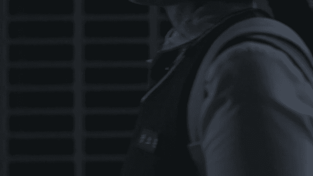 Student in school uniform passing through a dark place at night