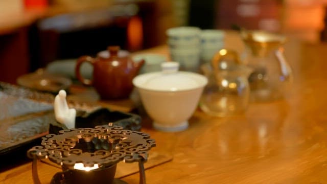 Teapots on a wooden table in a warm atmosphere