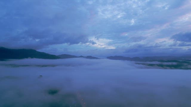 Clouds covering mountains at dawn
