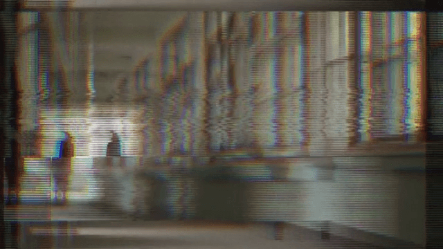 Crackling Screen Reflecting a Woman Standing in the Hallway