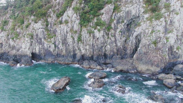 Rocky cliffside with waves crashing