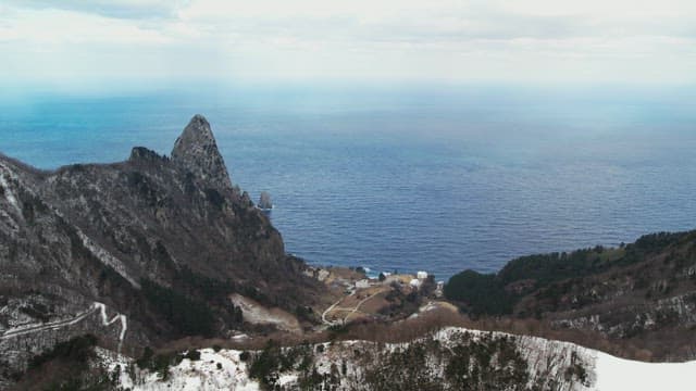 Snowy Coastal Cliffs Overlooking the Ocean