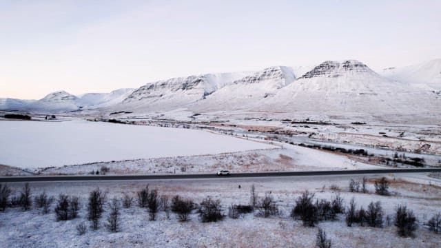 Snowy mountains and road with cars