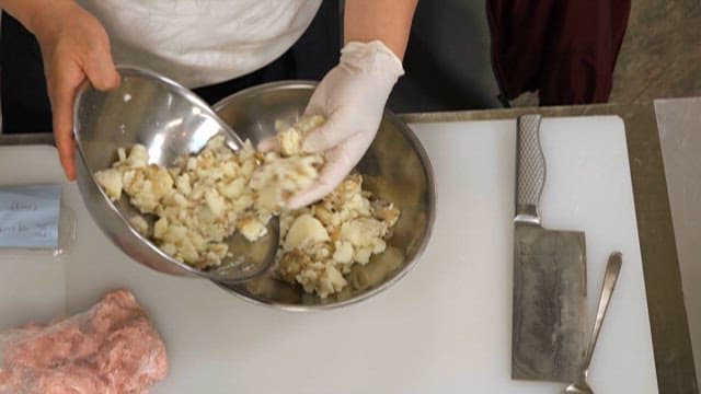 Mashing Potatoes in a Metal Bowl