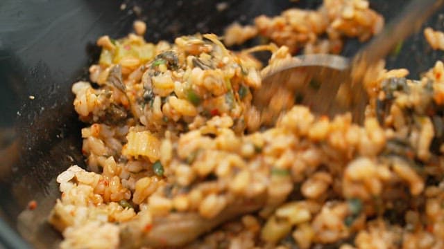 Mixing deliciously seasoned dried radish greens rice with a spoon